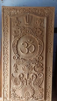 an intricately carved wooden panel in the shape of a sun and moon