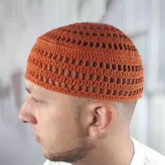 a man wearing an orange crocheted hat