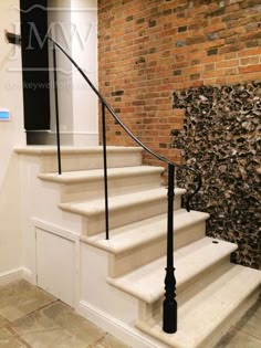 a set of stairs leading up to a brick wall