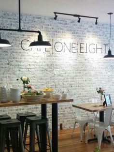 the interior of a restaurant with white brick walls