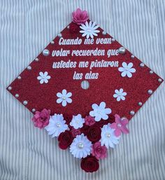 a graduation cap decorated with flowers and words