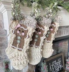 three stockings hanging from a mantel decorated with christmas decorations