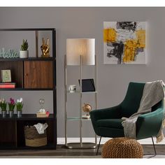 a living room scene with focus on the green chair and the lamp in the corner