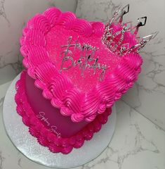 a pink heart shaped cake with a tiara on top