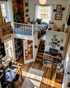 a loft with stairs leading up to the second floor, and a bed on top of it