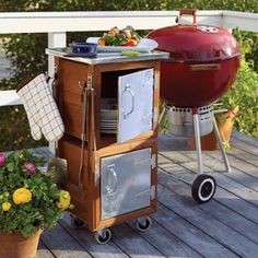 an outdoor bbq grill on a deck next to some vegetables and other food items