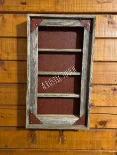 an old window is hanging on the side of a wooden wall with words above it