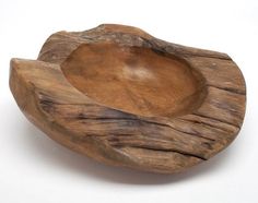 a wooden bowl sitting on top of a white table