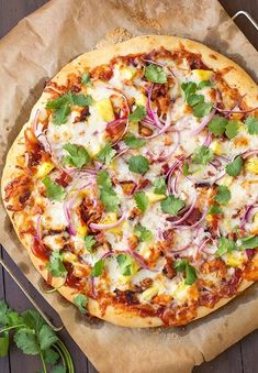 a pizza sitting on top of a pan covered in cheese and veggie toppings