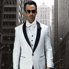 "This Dinner Jacket Tuxedo Is A Modern Cut In A Classic Style. The Fabric Is Elegant White Lace. It Features A One Button Closure, Matching Satin Shawl Lapel, And Side Vents. This Comes In A Modern Fit And Includes The Jacket, Pants, And Matching Vest." White Tux, Button Shawl, Satin Shawl, Dinner Jacket, Modern Fit, Mens Suits, Blazer Suit, White Lace, Classic Style