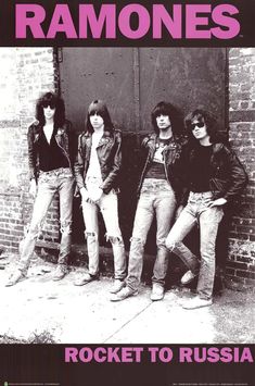 the ramons posing in front of a brick wall