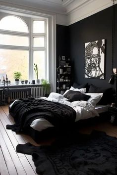 a bedroom with black walls and white bedding in the center, along with an art work on the wall