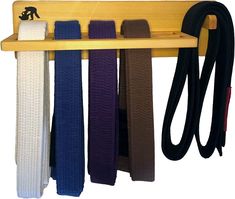 a wooden rack with belts hanging on it