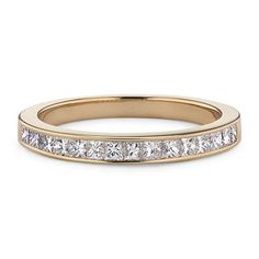 a yellow gold wedding band with princess cut diamonds on the side and channel set in between