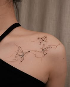 a woman with a butterfly tattoo on her shoulder