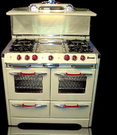 an old fashioned white stove with two ovens on it's front and back sides