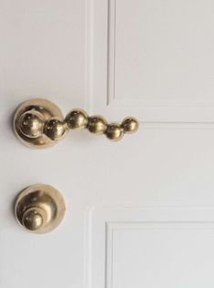 two brass handles on a white door