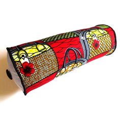 a red, yellow and black case with designs on the inside is hanging from a wall