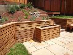 wooden planters are lined up on the side of a hill