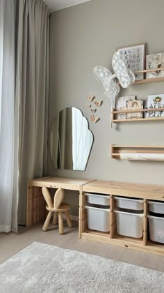 a living room filled with furniture next to a window and white rug on top of a hard wood floor