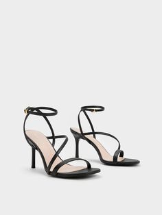 Black Asymmetric Strappy Heeled Sandals - CHARLES & KEITH US Black Heels White Background, Elegant Cross Strap Heels With 4-inch Heel, Modern Strappy Heels For Party, Modern Strap Heels For Party, Strappy Heels With Wrapped Heel For Date Night, Elegant Strappy Heels For Date Night, Sleek Strappy Heels With Wrapped Heel, Evening Heels With Cross Straps, Sleek Strappy Heels For Date Night