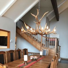 a dining room table with chairs and a chandelier