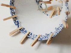 clothes pins are attached to a blue and white plate