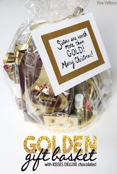 the golden gift basket is filled with chocolates and other holiday gifts for someone special