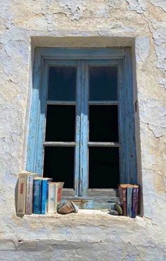 an open window with books in front of it