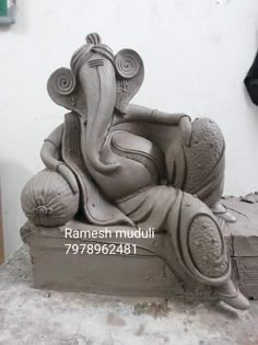 an elephant statue sitting on top of a box