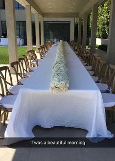 there is a long table with white cloth on it