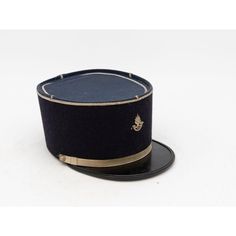 A rare French Military Academy Officer's hat or cap from the 1970s. These special and unique hats are part of the uniform of students studying to become officers in the French Military. This cap features a black leather brim on black felt with a blue top. There is a gold band around the brim and gold band at the top with a gold braid on the top and a gold emblem on the front. 6.25"w x 10"d x 4.25"h. Wear consistent with age and use. Military Academy, Black Tears, Unique Hats, Student Studying, Black Felt, Gold Bands, French Vintage, Black Leather, Mid Century