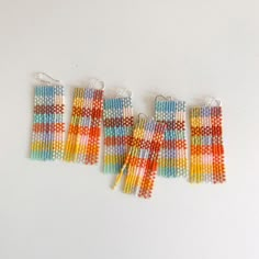 four pairs of multicolored seed beaded earrings