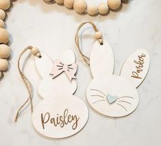 two wooden easter bunnies with name tags on them