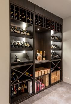 a wine cellar with many bottles on shelves