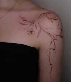 a woman's shoulder with flowers on it