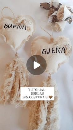 two heart shaped pillows with the words suenna written in spanish and english on them