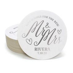 two round coasters with the words mr and mrs printed on them