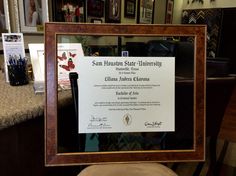 an award plaque is on display in front of a counter with pictures and other items