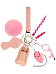 a pink keychain with various items attached to it, including a pom - pom