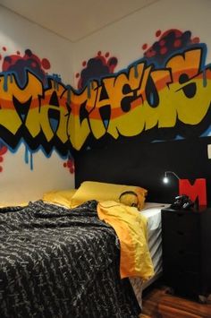 a bed room with a neatly made bed and graffiti on the wall