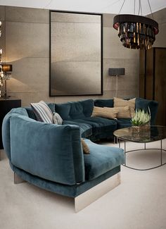 a living room filled with blue couches and pillows