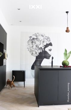 the kitchen is decorated in black and white with an art work on the wall behind it