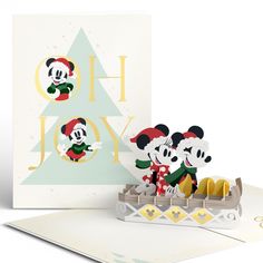 mickey and minnie mouses in a boat with christmas tree on the side, next to a holiday card