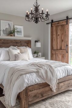 a bedroom with a bed, chandelier and two doors leading to the outside