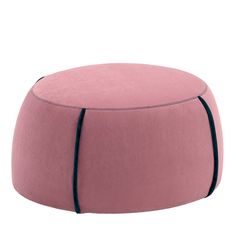 a pink ottoman with black piping on it