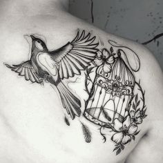 a man with a bird and cage tattoo on his back