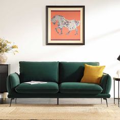 a living room with a green couch and two lamps on the side tables in front of it