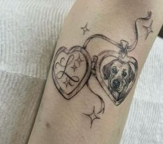 a heart shaped tattoo with a dog's face inside