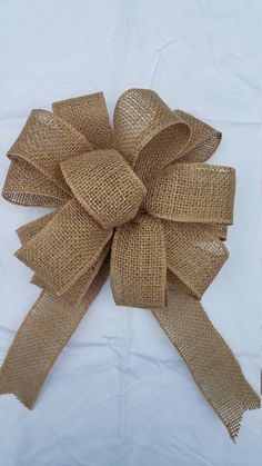 a close up of a burlap bow on a white background